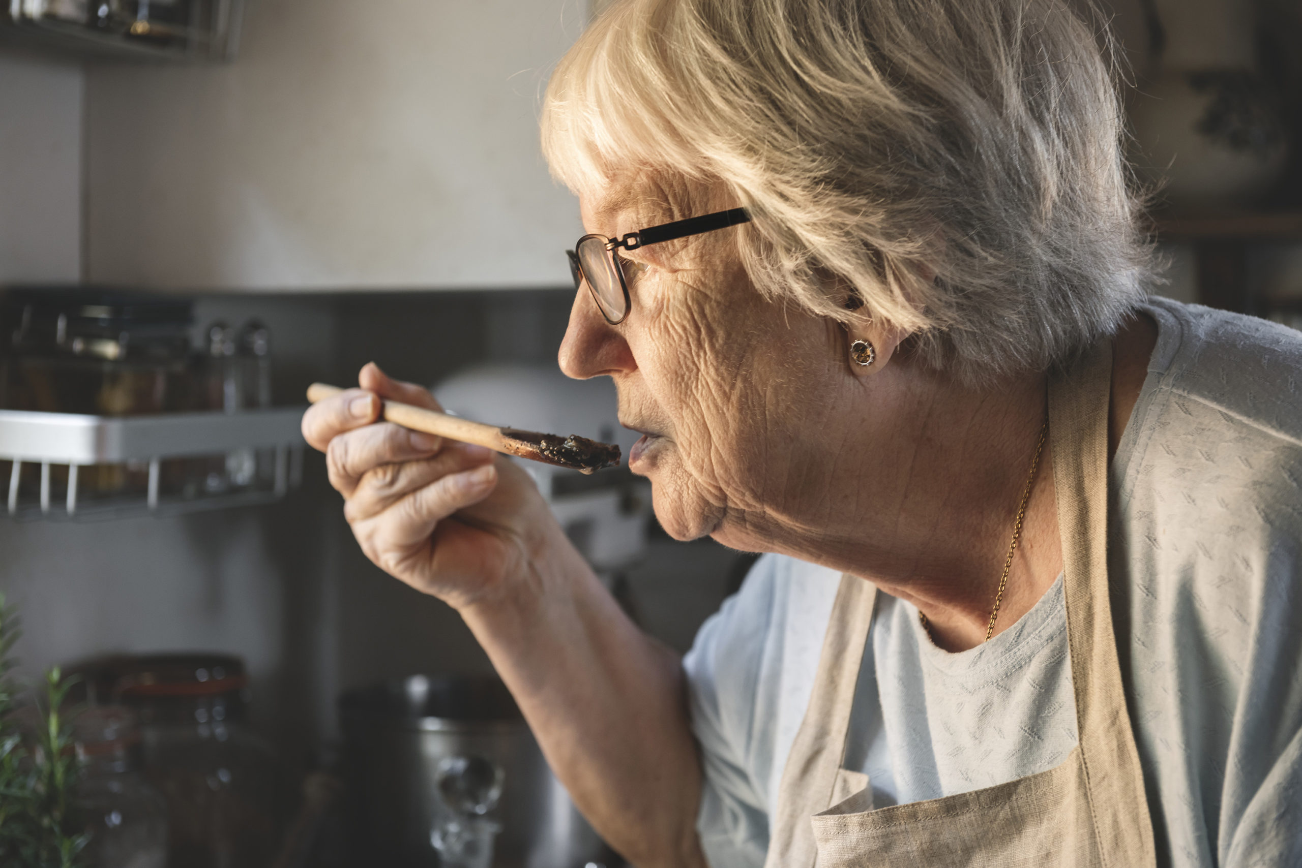 Senior woman preparing dinner in the kitchen