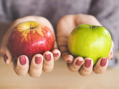 woman hand holding red and green apple fruit for diet