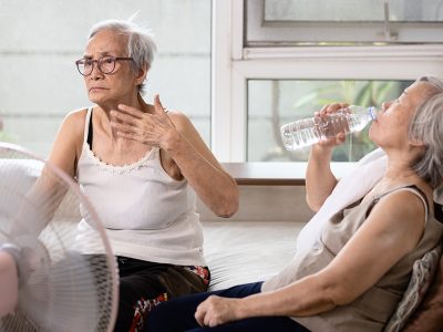 Asian elderly people who are hot and thirsty from high temperatu