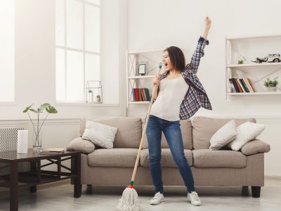 Happy woman after keeping her home clean and tidy